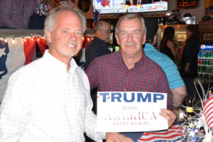 GOP candidates and fans watched returns from Tuesday's general election at Lone Wolf Energy in Billings. Billings residents Dave Malek, left, and retired U.S. Army veteran Dave Scott, right, pose with their Trump sign.